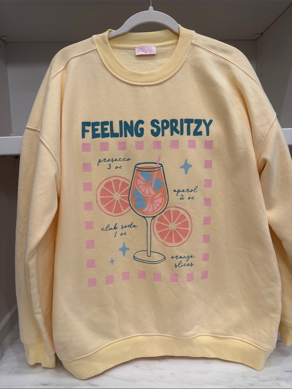 Pink Lily small soft yellow graphic sweatshirt.  Feeling Spritz logo. Like new